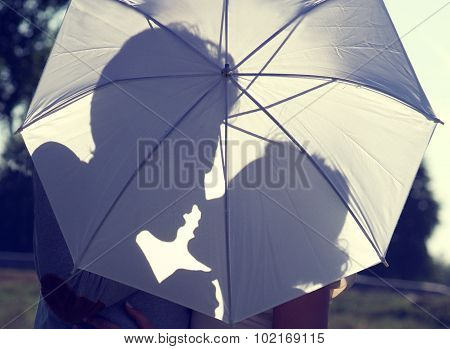 Sillhouetes of unrecognizable man and woman. Two people in love in sunset.Romantic couple