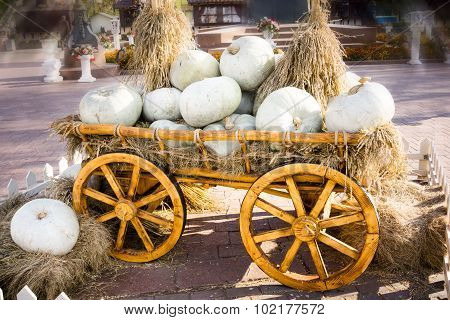 Old Carriage Cart Decorated With Autumn Pumpkins And Straw