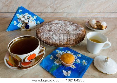 Coffee and cake are on the table.