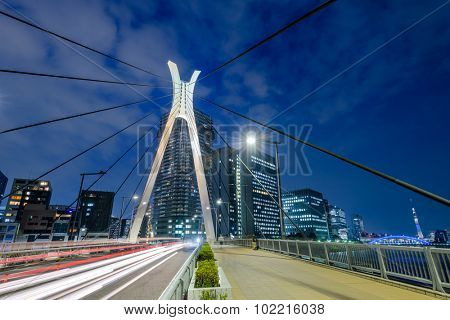 Tokyo, Japan bridge and cityscape at Tsukishima Island.