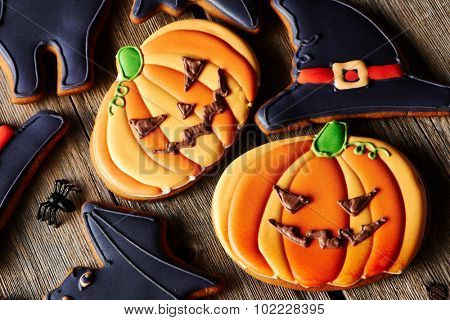 Halloween homemade gingerbread cookies over wooden table