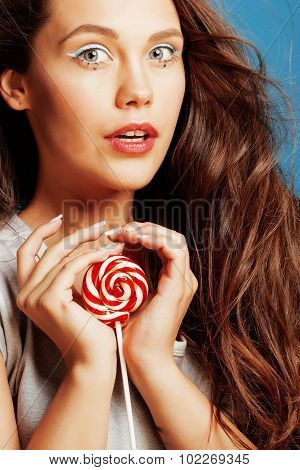 young pretty adorable woman with candy close up like doll