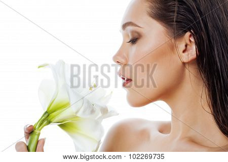 young pretty woman with  Amarilis flower close up isolated on white