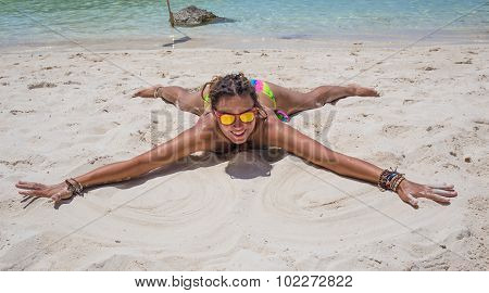 Young woman reaxing on the beach at exotic resort