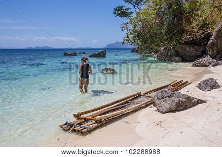 Young woman reaxing on the beach at exotic resort