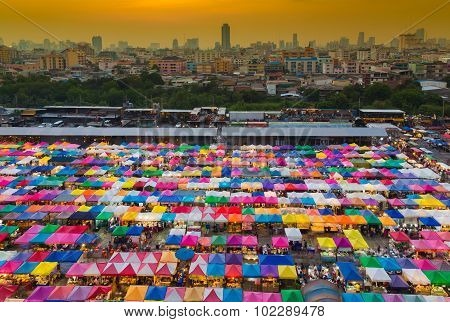 Aerial view of city flea market or weekend market with city business park background