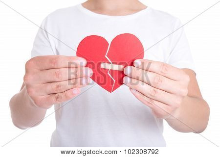 Young Man Holding Broken Heart With Plaster
