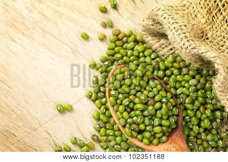 Close Up Green Mung Beans In Wooden Spoon On Wood Plate