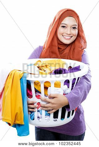 Housewife Wearing Hijab Carrying Laundry Basket Full Of Dirty Clothes