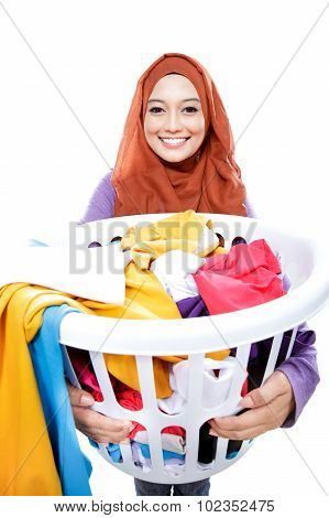 Housewife Wearing Hijab Carrying Laundry Basket Full Of Dirty Clothes