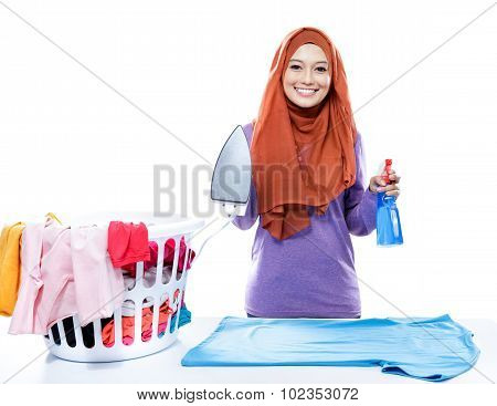 Young Woman Wearing Hijab Jolding Iron And Perfume Spray