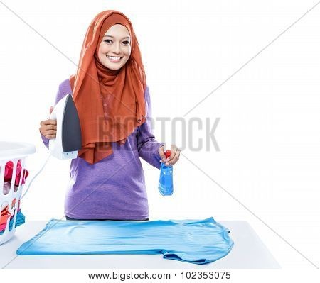 Young Woman Wearing Hijab Jolding Iron And Perfume Spray