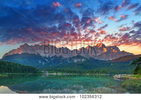 Fantastic sundown on mountain lake Eibsee, located in the Bavaria, Germany. Dramatic unusual scene. Alps, Europe.