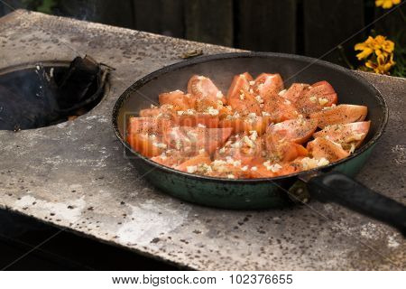 Tomatoes grilled over an open fire