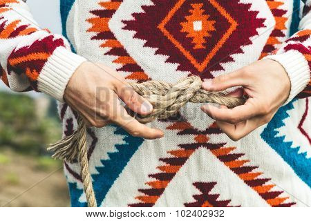 Man hands holding rope knot Travel Lifestyle survival concept
