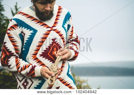 Man hands holding rope knot Travel Lifestyle survival concept