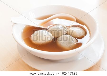 Rice And Sesame Dumpling In Ginger Syrup