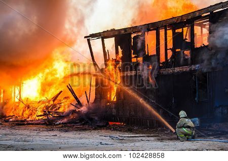 Fireman Extinguishes A Burning House