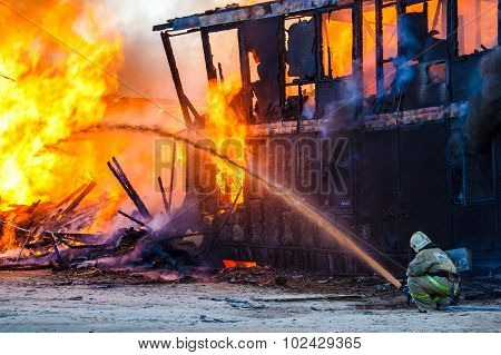 Fireman Extinguishes A Burning House