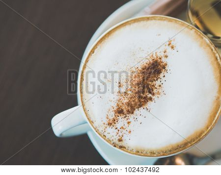 Vintage Tone Of Cup Of Hot Capuchino Coffee On The Brown Table