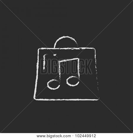 Bag with music note hand drawn in chalk on a blackboard vector white icon isolated on a black background.