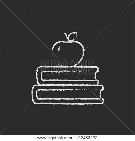 Books with apple on top hand drawn in chalk on a blackboard vector white icon isolated on a black background.