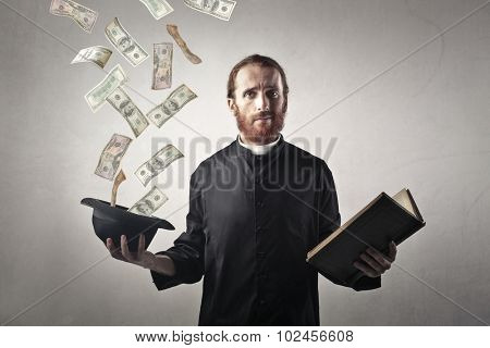 Money from the priest's hat