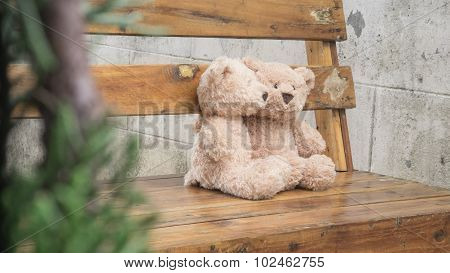 Teddybears on a park bench, selective focus