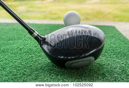 Close-up Of A Golf Ball And A Golf Wood On A Driving Range