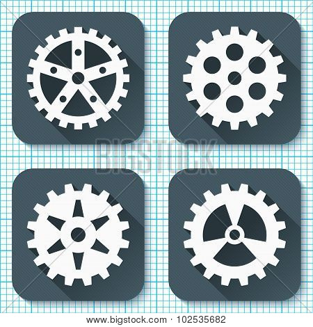 Set of four flat gear icons with long shadows on a graph paper background.