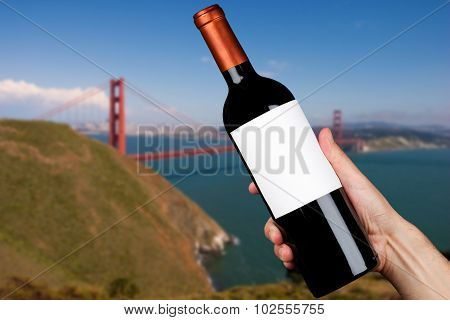 Hand holding a bottle of wine in San Francisco