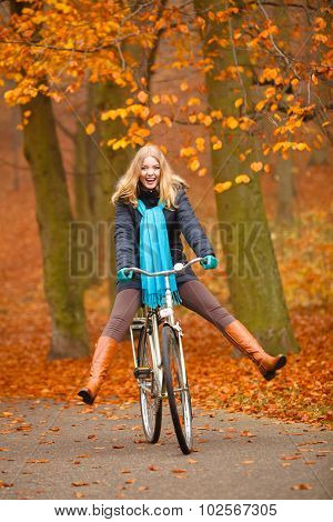 Girl Relaxing In Autumnal Park With Bicycle