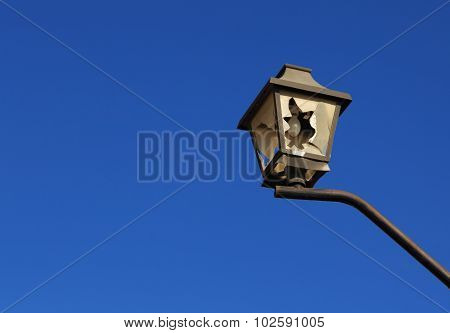 Broken City Light On The Blue Sky Background.