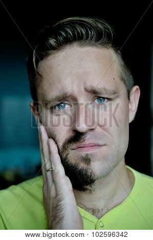 Young man with a beard on half of the face.