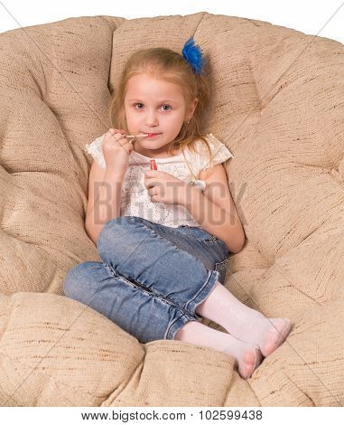 Little girl sitting in armchair