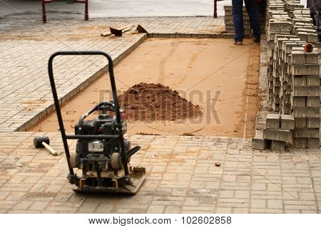 induration sand and laying paving slabs