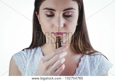 Pretty woman taking alternative tincture on white background