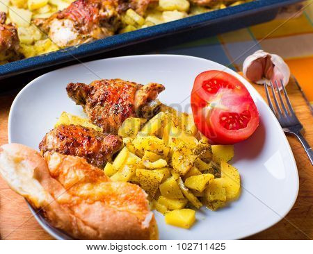 Plate Of Chicken And Potatoes Baked On A Grill