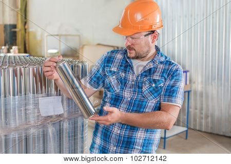 Worker in safety helmet at the storage