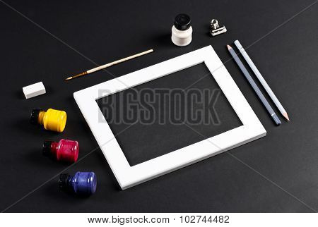 Template With White Photo Frame On Pink Paper With Brushes And Gouache And Pencils. Painter Workplac