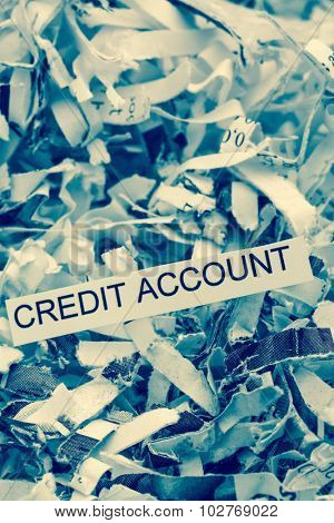 papierschnitzel tagged with credit account, symbolfoto for data destruction, finance and credit