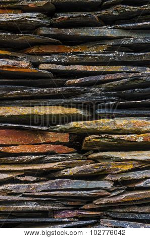 Background detail of rural house with piled schist stone blades