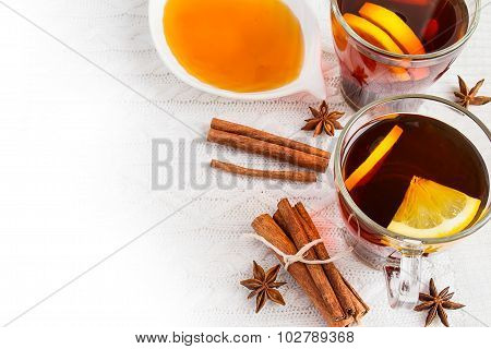 Honey,  Tea With Lemon And Cinnamon Sticks On A White Background