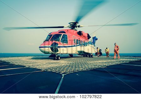 The Officer Take Care Passenger To Embark Helicopter At Oil Rig