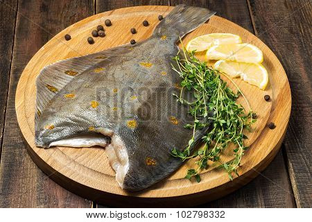Raw Plaice With Pepper, Thyme And Lemon On The Board