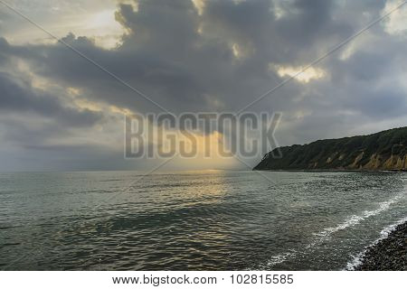 Sunset over the coast .