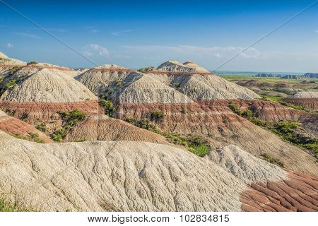 Badlands With Red Striped Hills