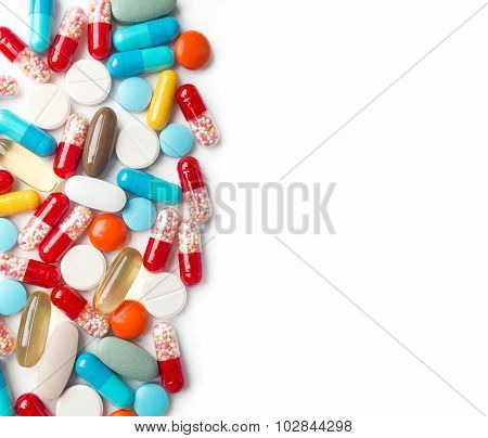 A Top View Of A Heap Of Colourful Medicine Pills And Capsules On White Surface. Copy Space For The A