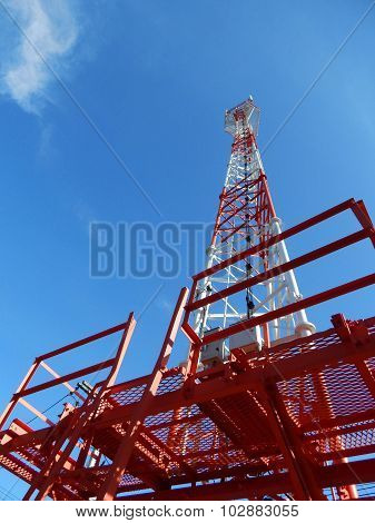 Telecommunication Tower Red And White With Blue Sky Background