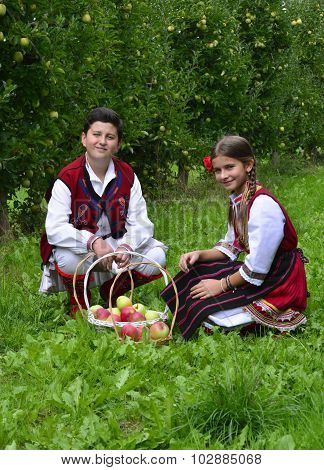 Resen, Macedonia. September, 27  2015- Boy And Girl In Traditional Clothes Posing With Apples During